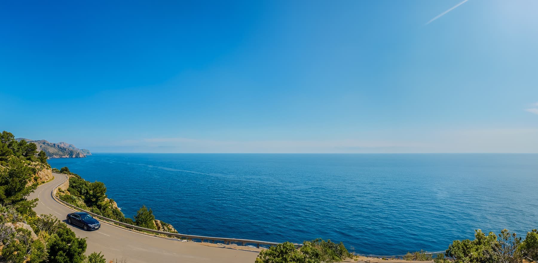 A private transfer drives along the Antalya coastline
